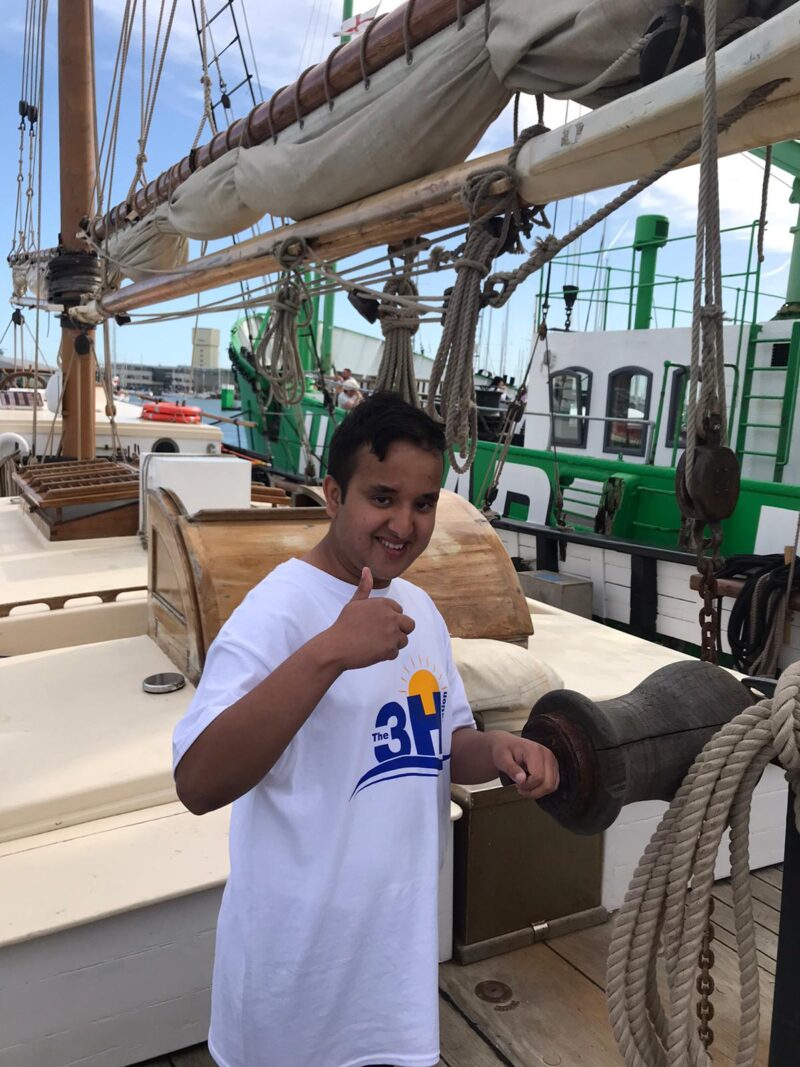 Sailing holiday crew member in a The 3H Foundation t-shirt.